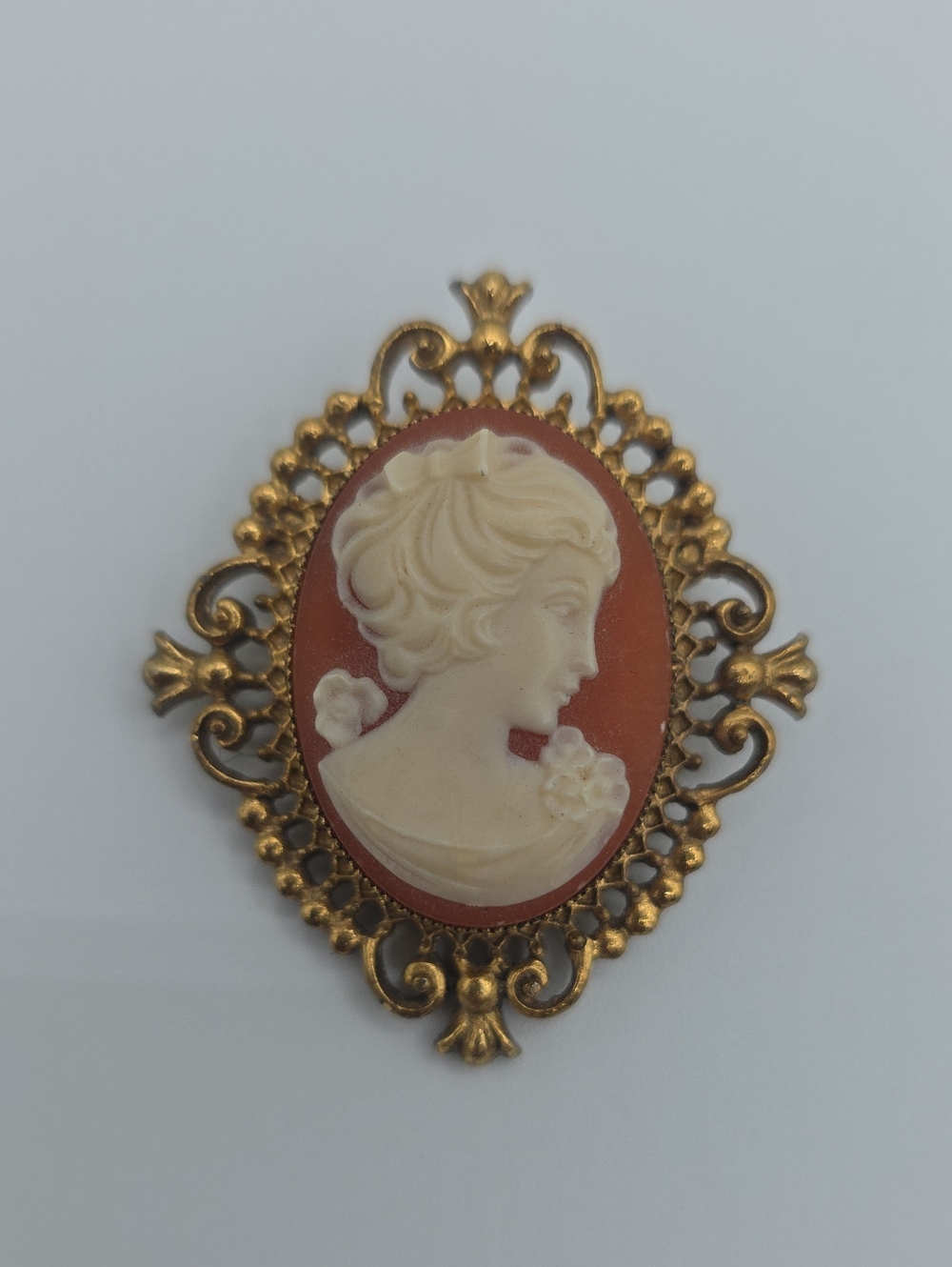 Avon Gold-Tone Coral and Cream Cameo Brooch